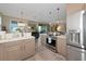 Stylish kitchen with stainless steel appliances and a view of the living area at 7106 Grand Estuary Trl # 102, Bradenton, FL 34212