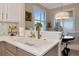 Bright kitchen featuring a sink, white countertops, tile backsplash, and nearby breakfast nook at 7106 Grand Estuary Trl # 102, Bradenton, FL 34212