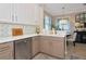Bright kitchen featuring stainless appliances, white countertops and patterned tile backsplash at 7106 Grand Estuary Trl # 102, Bradenton, FL 34212