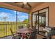 Relaxing screened lanai featuring a ceiling fan, comfortable seating, and a beautiful view of the golf course and pond at 7106 Grand Estuary Trl # 102, Bradenton, FL 34212