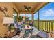 Inviting screened lanai offering comfortable seating, a ceiling fan, and a peaceful view of the surrounding community at 7106 Grand Estuary Trl # 102, Bradenton, FL 34212