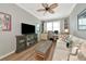 Comfortable living room includes a sofa, TV, and built-in shelves at 7106 Grand Estuary Trl # 102, Bradenton, FL 34212