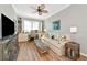 Comfortable living room includes a sofa, TV, and built-in shelves at 7106 Grand Estuary Trl # 102, Bradenton, FL 34212