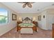 The spacious main bedroom features a carved wood bed frame, upholstered furniture, and lots of light at 7106 Grand Estuary Trl # 102, Bradenton, FL 34212
