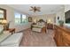 Bright main bedroom featuring a carved wood bed frame, upholstered furniture, and lots of light at 7106 Grand Estuary Trl # 102, Bradenton, FL 34212