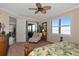 Sitting area in main bedroom has a white lounge chair and access to the screened in lanai at 7106 Grand Estuary Trl # 102, Bradenton, FL 34212