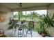 Inviting screened balcony featuring comfortable seating and scenic golf course views at 7155 Boca Grove Place Pl # 202, Lakewood Ranch, FL 34202