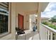 Cozy condo balcony with a chair, plant, and view of lush greenery, perfect for relaxing outdoors at 7155 Boca Grove Place Pl # 202, Lakewood Ranch, FL 34202