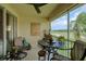 Cozy screened balcony with seating area overlooking a beautiful golf course view at 7155 Boca Grove Place Pl # 202, Lakewood Ranch, FL 34202