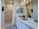 Bathroom featuring double sinks, shower with curtain, and tile flooring at 7155 Boca Grove Place Pl # 202, Lakewood Ranch, FL 34202