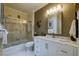Well-lit bathroom featuring a shower over bath, white vanity with marble countertop, and modern fixtures at 7155 Boca Grove Place Pl # 202, Lakewood Ranch, FL 34202