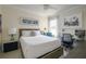Serene bedroom featuring a comfortable bed, soft lighting, and a dedicated workspace at 7155 Boca Grove Place Pl # 202, Lakewood Ranch, FL 34202