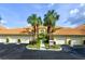 Charming, well-maintained condo with attached garages, beautiful landscaping, and palm trees at 7155 Boca Grove Place Pl # 202, Lakewood Ranch, FL 34202