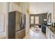Modern kitchen with stainless steel appliances and view into stylish living room at 7155 Boca Grove Place Pl # 202, Lakewood Ranch, FL 34202