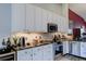 Modern kitchen boasting granite countertops, stainless steel appliances, and white cabinetry at 7155 Boca Grove Place Pl # 202, Lakewood Ranch, FL 34202