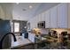 Open kitchen concept with stainless steel appliances, granite countertops, and white cabinets at 7155 Boca Grove Place Pl # 202, Lakewood Ranch, FL 34202