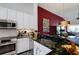 Modern kitchen with stainless steel appliances, granite countertops, and stylish sink at 7155 Boca Grove Place Pl # 202, Lakewood Ranch, FL 34202