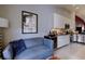 Stylish living area with kitchen view, featuring seating, decor, and sleek appliances at 7155 Boca Grove Place Pl # 202, Lakewood Ranch, FL 34202