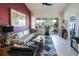 Bright living area with an L-shaped sofa, glass coffee table, and access to an outdoor balcony at 7155 Boca Grove Place Pl # 202, Lakewood Ranch, FL 34202
