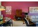 Elegant dining area adjacent to a living space, featuring sleek furniture and a colorful accent wall at 7155 Boca Grove Place Pl # 202, Lakewood Ranch, FL 34202