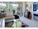 Cozy living room featuring modern decor, a comfortable sofa, and a view to the outdoor patio at 7155 Boca Grove Place Pl # 202, Lakewood Ranch, FL 34202