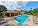 Sparkling community pool with ample lounge chairs, surrounded by lush landscaping at 7155 Boca Grove Place Pl # 202, Lakewood Ranch, FL 34202