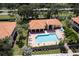 Aerial view of a community pool, covered outdoor seating, and lounge chairs at 7155 Boca Grove Place Pl # 202, Lakewood Ranch, FL 34202