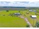 Wide aerial view of a home and extensive property including outbuildings and greenery at 7745 Wauchula Rd, Myakka City, FL 34251