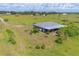 Aerial view of the property showing the home, yard, and the covered deck at 7745 Wauchula Rd, Myakka City, FL 34251