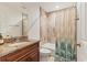 Bathroom featuring wood vanity, granite countertop, and tiled shower and tub at 7745 Wauchula Rd, Myakka City, FL 34251