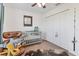 Charming bedroom featuring a crib, chair and ottoman, ceiling fan and neutral carpet at 7745 Wauchula Rd, Myakka City, FL 34251
