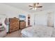 Bedroom features light carpet, outdoor view and dark wood dresser and TV at 7745 Wauchula Rd, Myakka City, FL 34251