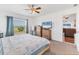 Bedroom with light carpet, and outdoor views with a TV mounted above matching wood dressers at 7745 Wauchula Rd, Myakka City, FL 34251