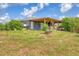 Backyard exterior showing a covered deck and lots of surrounding shrubbery at 7745 Wauchula Rd, Myakka City, FL 34251
