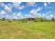 Home exterior surrounded by mature trees and an expansive yard at 7745 Wauchula Rd, Myakka City, FL 34251