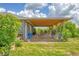 Charming home exterior featuring a covered wooden deck at 7745 Wauchula Rd, Myakka City, FL 34251