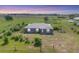 Aerial view of a well-kept home with a large front yard in a rural setting at 7745 Wauchula Rd, Myakka City, FL 34251