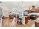 Kitchen featuring stainless steel appliances, center island with barstool seating, and wood-look flooring at 7745 Wauchula Rd, Myakka City, FL 34251