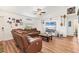 Bright and open living room with wooden floors, a ceiling fan, and comfortable seating at 7745 Wauchula Rd, Myakka City, FL 34251