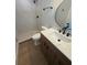 Modern bathroom featuring walk-in shower with stylish tile and a wood vanity at 808 25Th W Ave, Palmetto, FL 34221