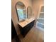 Bathroom featuring double vanity with modern arched mirrors and gold hardware at 808 25Th W Ave, Palmetto, FL 34221