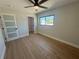 This spacious bedroom features wood-look tile floors, large window, and a door with privacy glass at 808 25Th W Ave, Palmetto, FL 34221