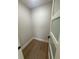 Small walk-in closet with tile floor and natural lighting through glass door at 808 25Th W Ave, Palmetto, FL 34221