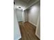 Hallway featuring wood-look tile flooring, trim, neutral paint, and access to walk in closet at 808 25Th W Ave, Palmetto, FL 34221