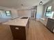 Open kitchen with a marble-topped kitchen island, cooktop, built-in oven, and stainless steel dishwasher at 808 25Th W Ave, Palmetto, FL 34221