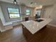 Bright kitchen with stainless steel appliances, island cooktop, marble countertops and a window bench at 808 25Th W Ave, Palmetto, FL 34221