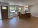 Open kitchen featuring an island with white countertops and stainless steel appliances and a large window bench at 808 25Th W Ave, Palmetto, FL 34221