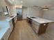 Bright kitchen featuring an island with cooktop, oven, and white countertops with stainless steel appliances at 808 25Th W Ave, Palmetto, FL 34221