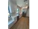 Kitchen with a stainless steel refrigerator, stainless steel dishwasher, white cabinets, and marble bench seat at 808 25Th W Ave, Palmetto, FL 34221