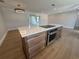 Open kitchen with marble top island featuring a cooktop, built-in oven, and lots of storage drawers at 808 25Th W Ave, Palmetto, FL 34221